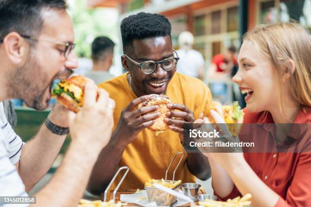 Friends And Fast Food Stock Photo - Download Image Now - Eating, Burger, Fast Food Restaurant