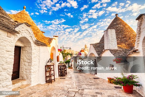 istock Famous Trulli Houses during a Sunny Day with Bright Blue Sky in Alberobello, Puglia, Italy 1345015971