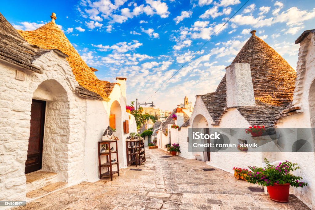 Famous Trulli Houses during a Sunny Day with Bright Blue Sky in Alberobello, Puglia, Italy Italy Stock Photo