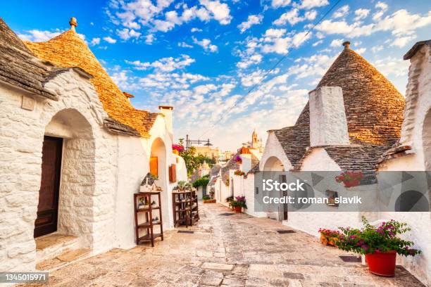 Famous Trulli Houses During A Sunny Day With Bright Blue Sky In Alberobello Puglia Italy Stock Photo - Download Image Now
