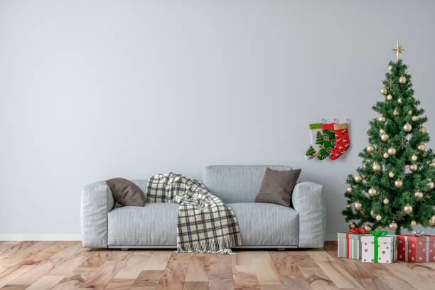istock Empty simple living room with gray sofa, Christmas tree and gifts 1345018226