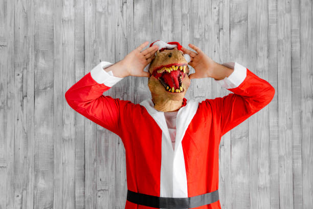 Dinosaur disguised as Santa Claus with hands on head