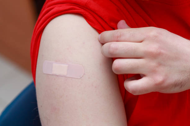 istock Patients shoulder with sealed plaster after coronavirus vaccination. Real procedure and situation 1345019482
