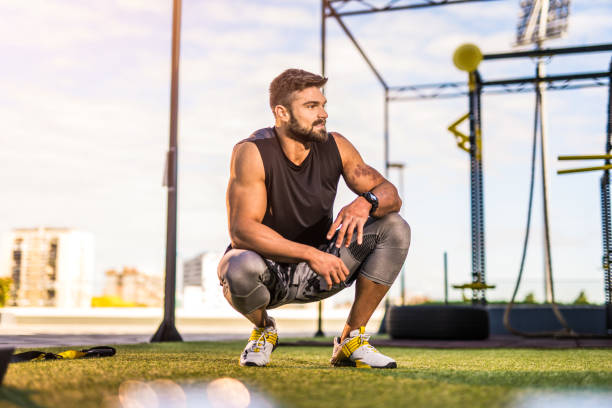 Young male athlete resting at the gym after a hard workout.