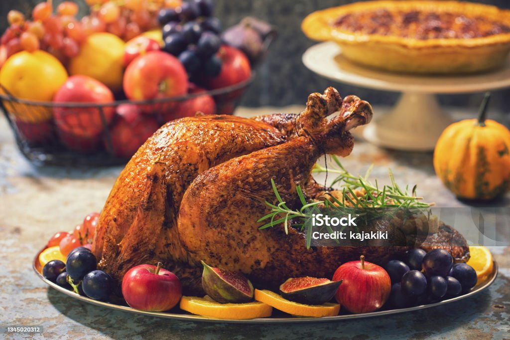 Preparing Stuffed Turkey with Side Dishes for Holidays Preparing traditional stuffed turkey with side dishes for Thanksgiving celebration Thanksgiving - Holiday Stock Photo