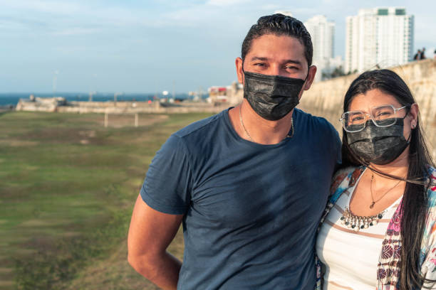 istock Couple with protective mask sharing in the open air 1345020691