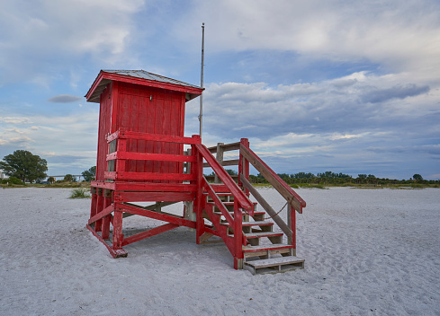 Lifeguard stand during a vibrant sunset at Sand Key Beach in Clearwater Florida USA