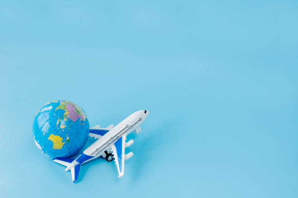 istock Airplane and globe on blue background. Summer or vacation concept. Copy space 1345028507