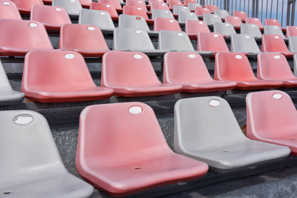 istock Empty plastic seats in a stadium. Matches to be played without fans 1345029661