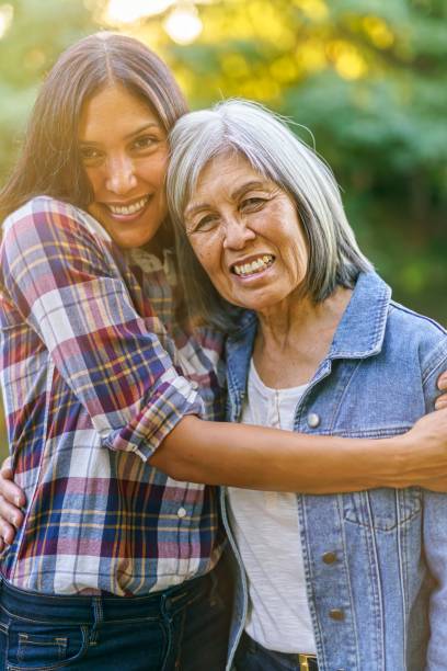 istock Affectionate mother and adult daughter embracing 1345030947