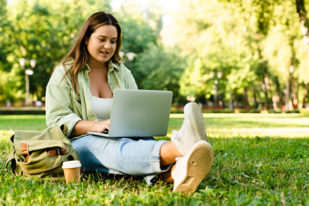 istock Relaxing young freelancer woman student working e-learning on distance remotely on laptop, doing homework, preparing project for deadline in park lawn 1345038813