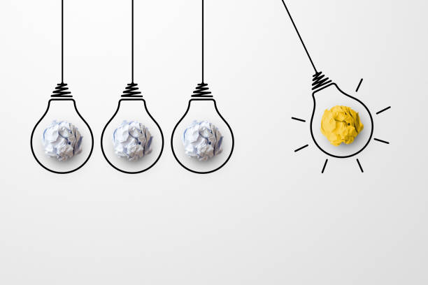 istock Concept creative idea and innovation. Paper scrap ball yellow colour outstanding different group with light bulb symbol 1345040296