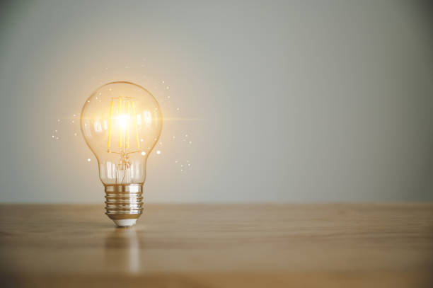 istock Light bulb on wood table with copy space. Concept of inspiration creative idea thinking and future technology innovation 1345040331
