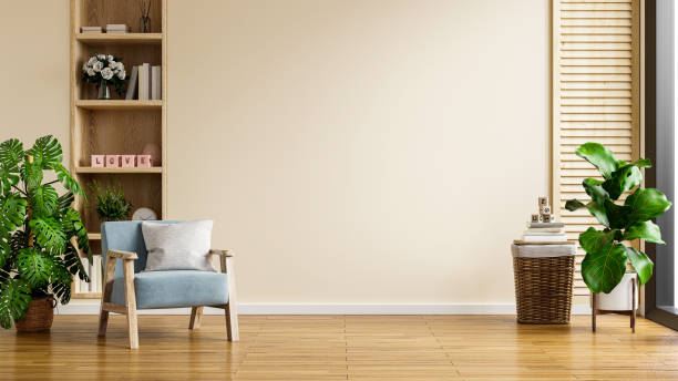 istock Modern minimalist interior with an armchair on empty cream color wall background. 1345040354
