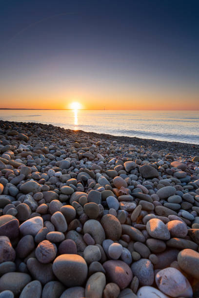 istock Pebble on the Ontario Lake Shore and Sunset 1345041146