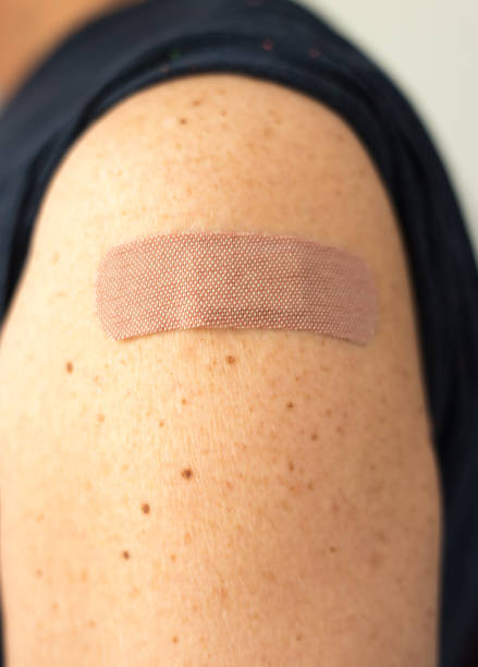 istock Post-Vaccination Bandage on Man's Arm 1345042746