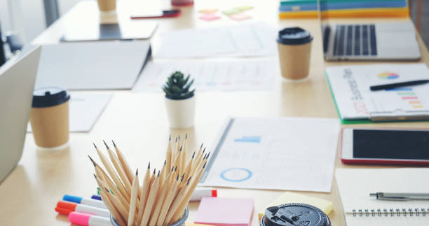 istock Meeting room Office laptop business financial document chart , graph on wooden table with coffee cup. Flat lay notebook computer laptop on office desk. No people business graph chart on meeting table 1345042749