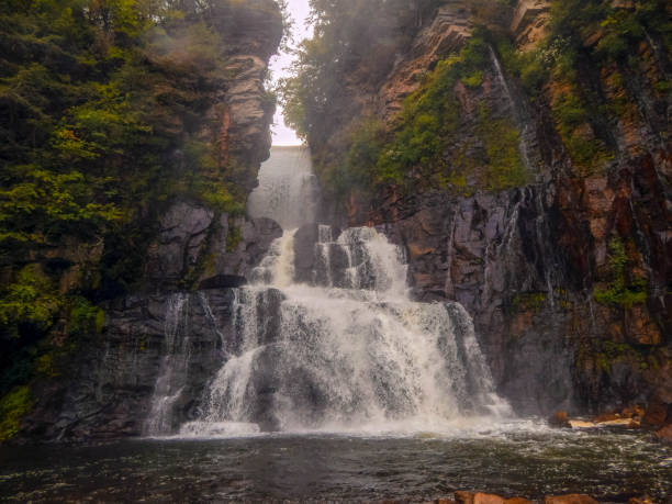 istock Waterfall in the middle of the woods 1345043788
