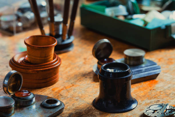 istock Watchmakers tools and a Jewellers Loupe on a workbench 1345043880