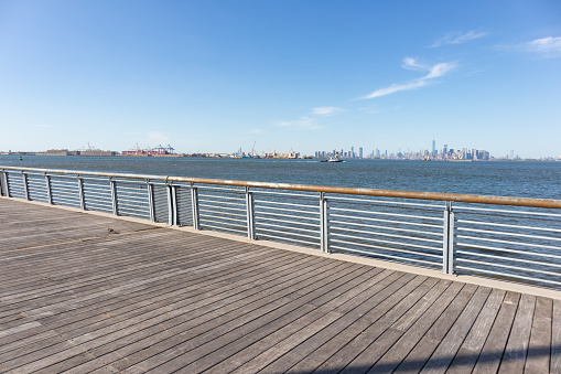 The empty wooden St. George waterfront park along New York Harbor in Staten Island of New York City