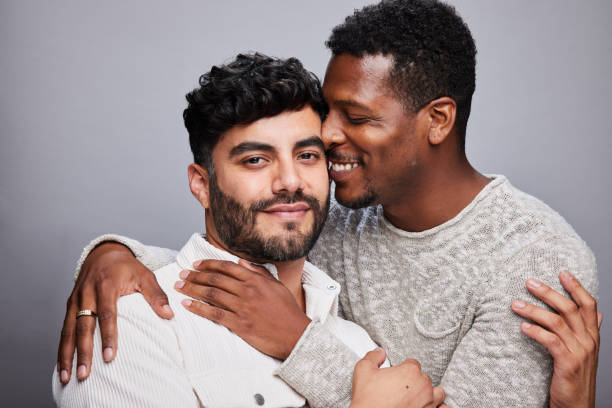 istock Smiling young man standing with his affectionate partner on a gray background 1345048899