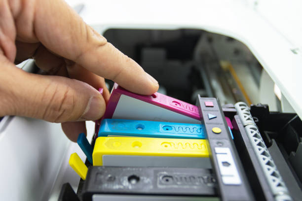 Technicians are install setup the ink cartridge of a inkjet printer the device of office automate for printing stock photo