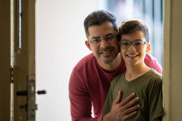 istock Portrait father and son smiling looking at the camera 1345052941