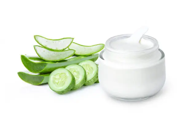 Beauty cosmetic skin care cream with fresh green aloevera leaf and cucumber isolated on white background.