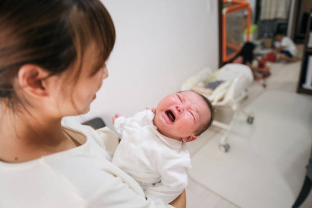 istock Mother and crying newborn 1345056028