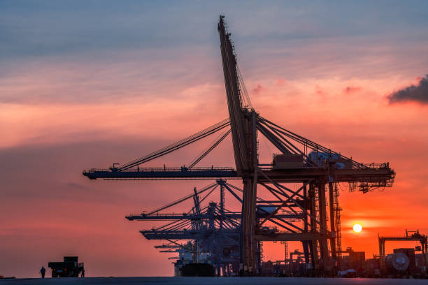 istock Container dock crane construction shipment terminal in the port of harbour import export commercial trade business logistic and transportation of international. 1345058073