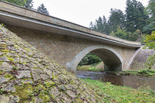 istock Stone bridge crosses a stream in Eagle mountains (Orlicke hory) during summer time. 1345058976