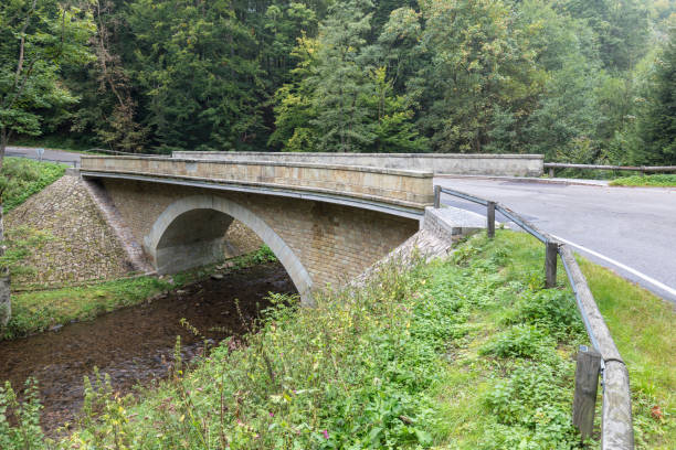 istock Stone bridge crosses a stream in Eagle mountains (Orlicke hory) during summer time. 1345058980