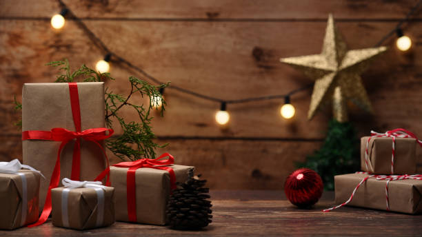 istock Christmas gift boxes and fir tree branches on wooden table. 1345059993