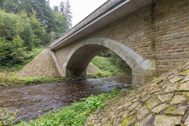istock Stone bridge crosses a stream in Eagle mountains (Orlicke hory) during summer time. 1345060061