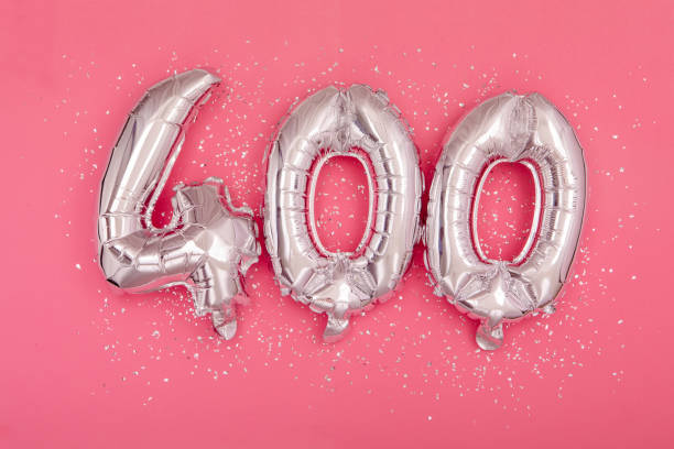 istock Silver balloon showing number 400 four hundred pink background 1345060086