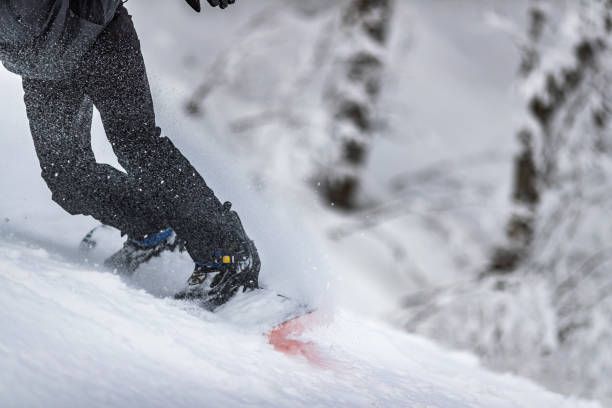istock Unrecognizable person snowboarding on a mountain. 1345060276