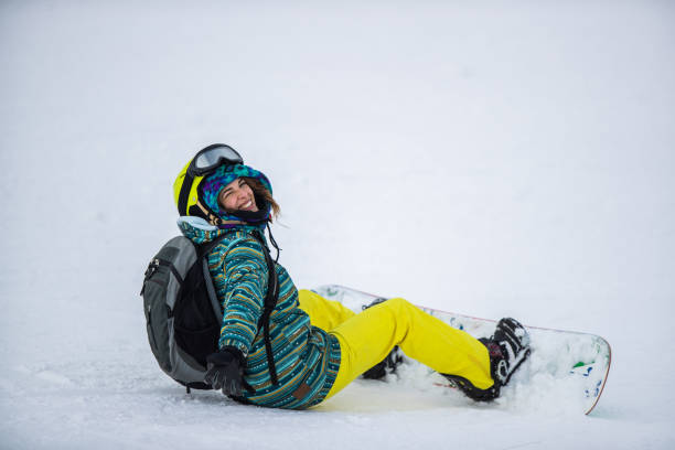 istock Happy woman resting from snowboarding on mountain. 1345060834