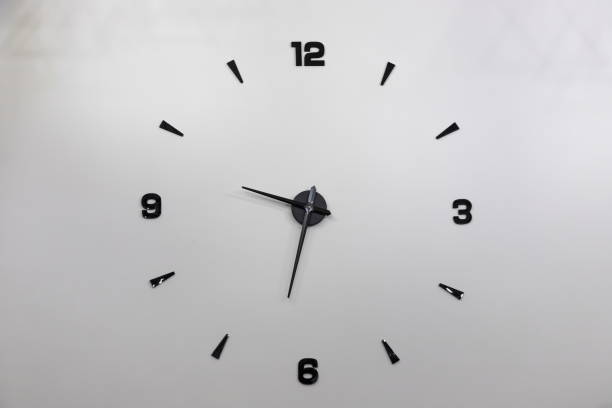 istock Minimalistic design of wall clock with black numbers 1345064020