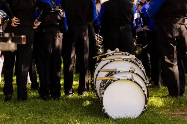 A set of drums sits behind a marching band