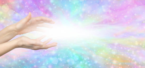 Reiki Lightworker Healing Hands and white light message banner female hands with white light between against a multicoloured ethereal shimmering background with copy space reiki photos stock pictures, royalty-free photos & images