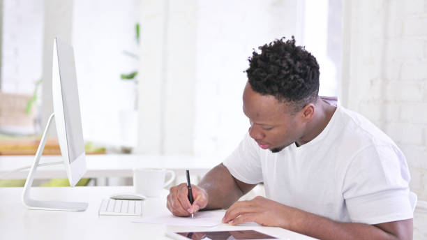 istock Writing Casual African Man in Office 1345068000