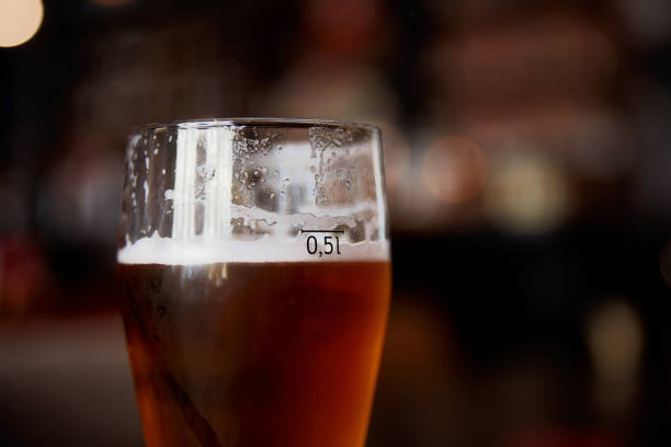 istock Glass of beer on a table in a bar on blurred bokeh background 1345070020
