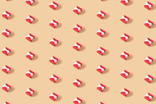 istock Creative Christmas isometric pattern made of red gift box on beige light brown background. Minimal Christmas or New Year concept. 1345070312
