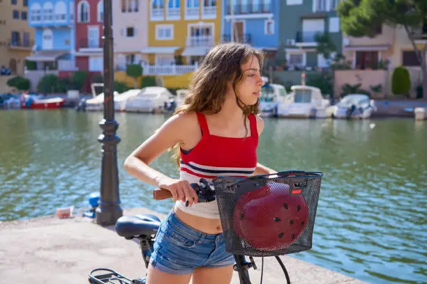 Girl riding a foldable e-bike in a Mediterranean port ebike