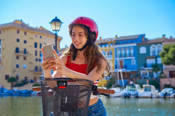 Girl riding a foldable e-bike in a Mediterranean marina port ebike