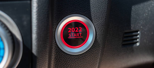 istock Finger press a car ignition button with 2022 START text inside modern electric automobile. New Year New You, resolution, change, goal, vision, innovation and planning concept 1345072858