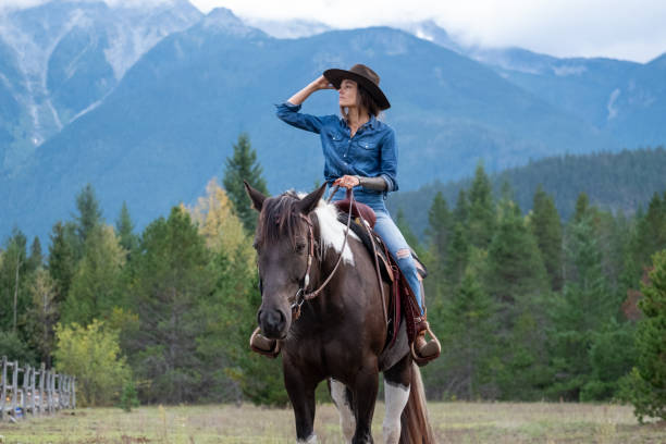 istock Woman riding her horse at a ranch 1345073824
