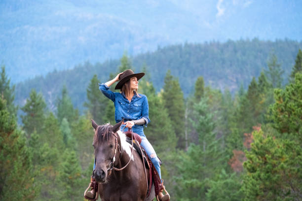 istock Woman riding her horse at a ranch 1345073834