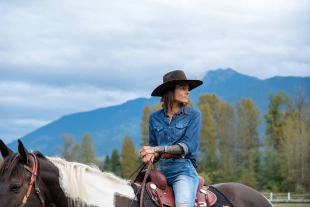 istock Woman riding her horse at a ranch 1345073849