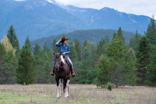 istock Woman riding her horse at a ranch 1345073867